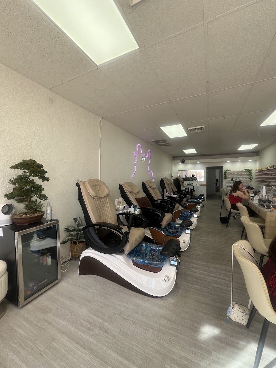 Inside Polish Me Studios: bright pedicure chairs and manicure stations