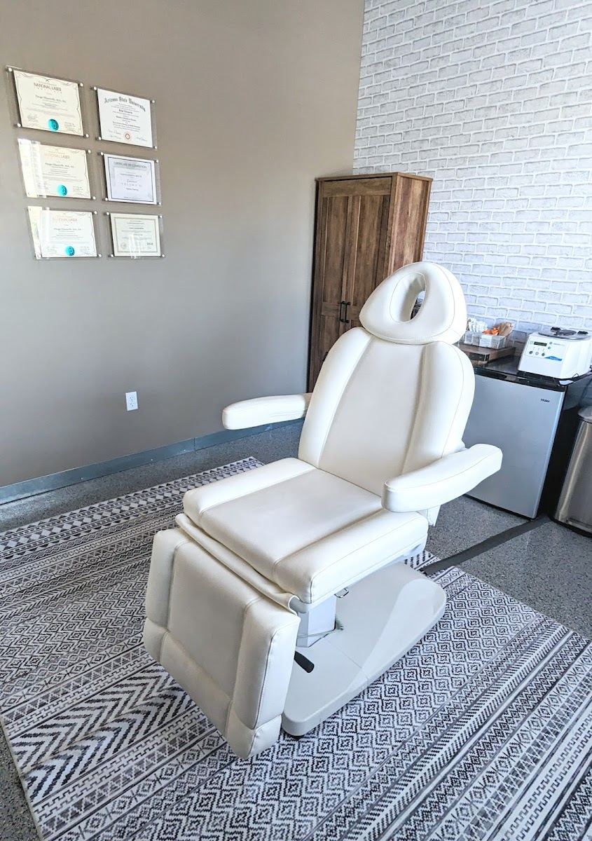 White treatment chair in the clean, bright studio room