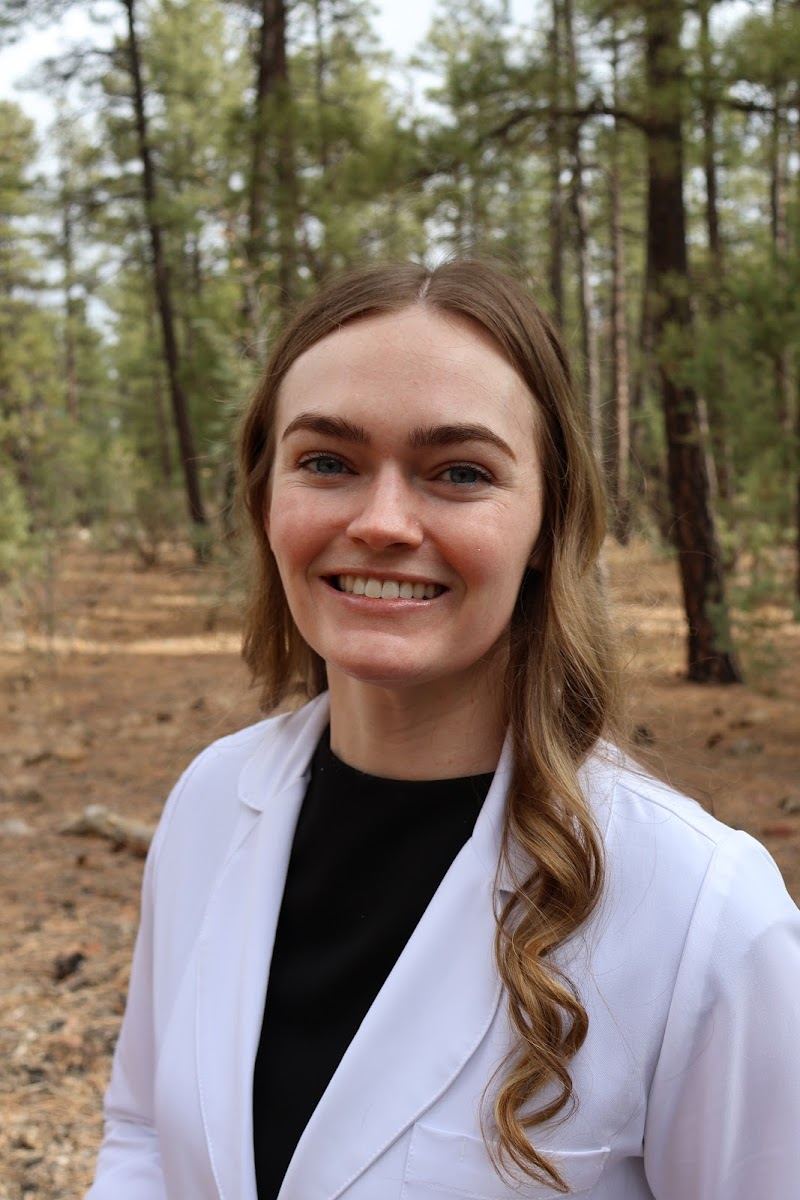 Smiling provider in a white coat, from the studio's Google photos