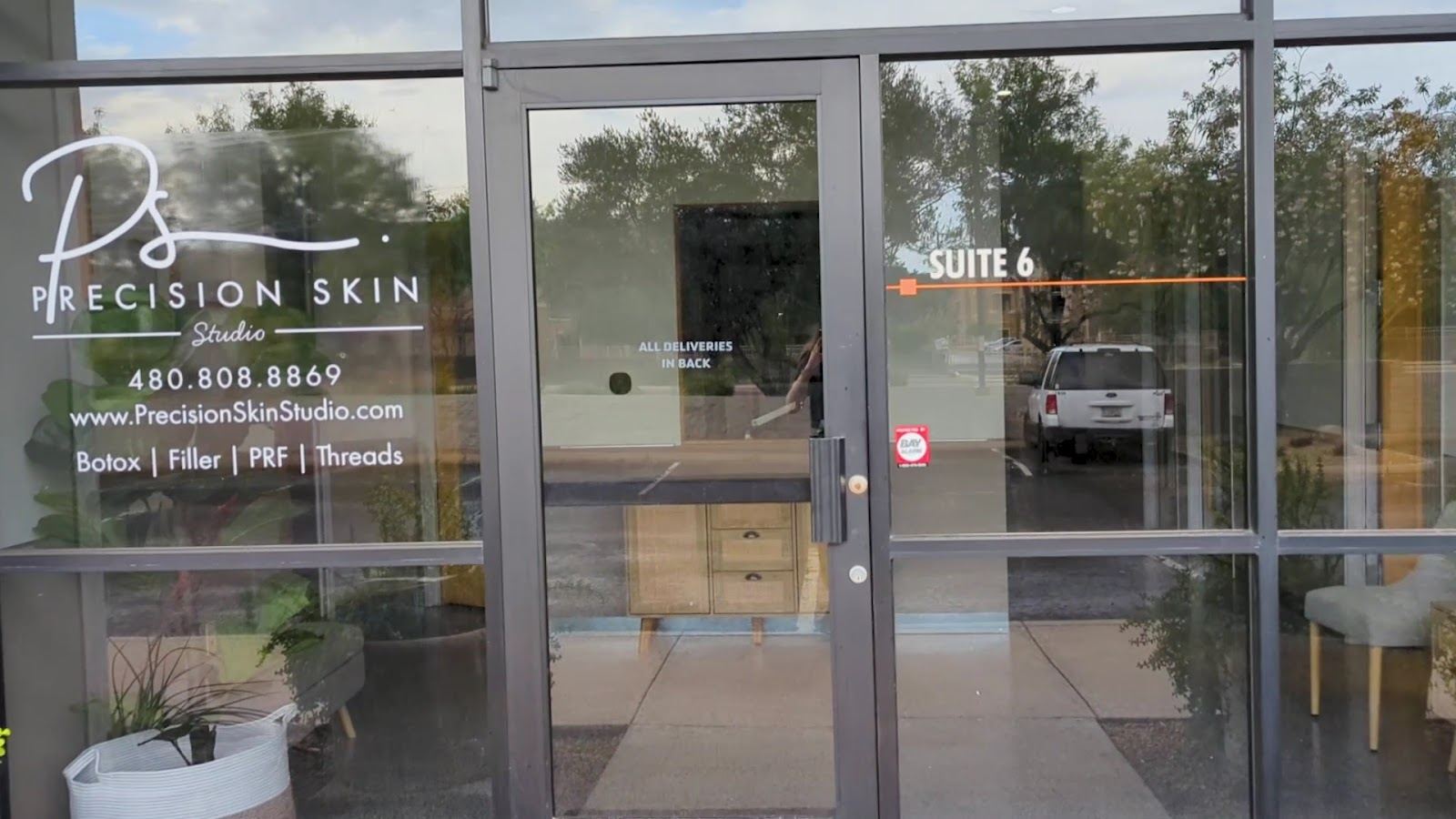 Precision Skin Studio storefront glass with the studio name, Suite 6