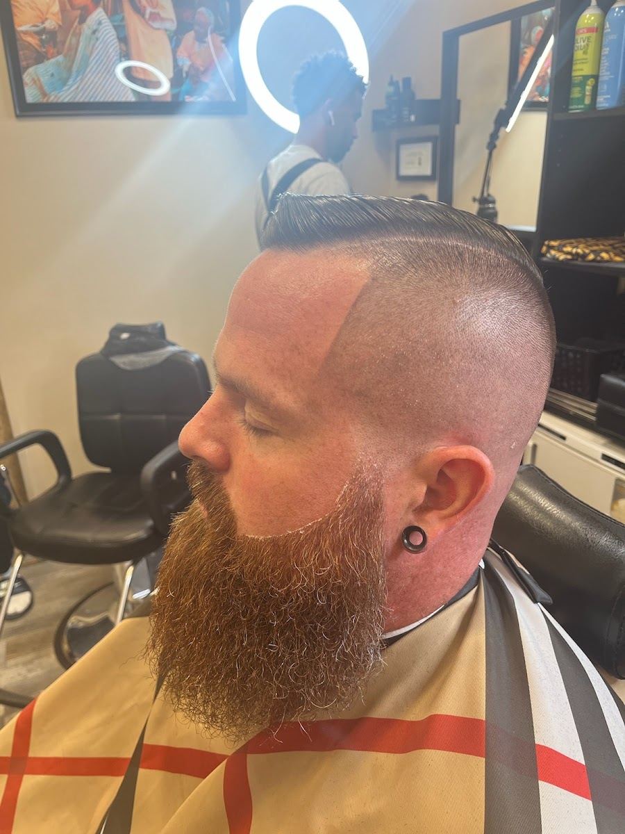 Client with a tight side fade and a long full beard shaped to a point