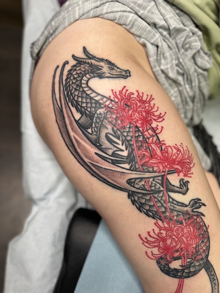 Dragon tattoo wrapped in red spider lilies