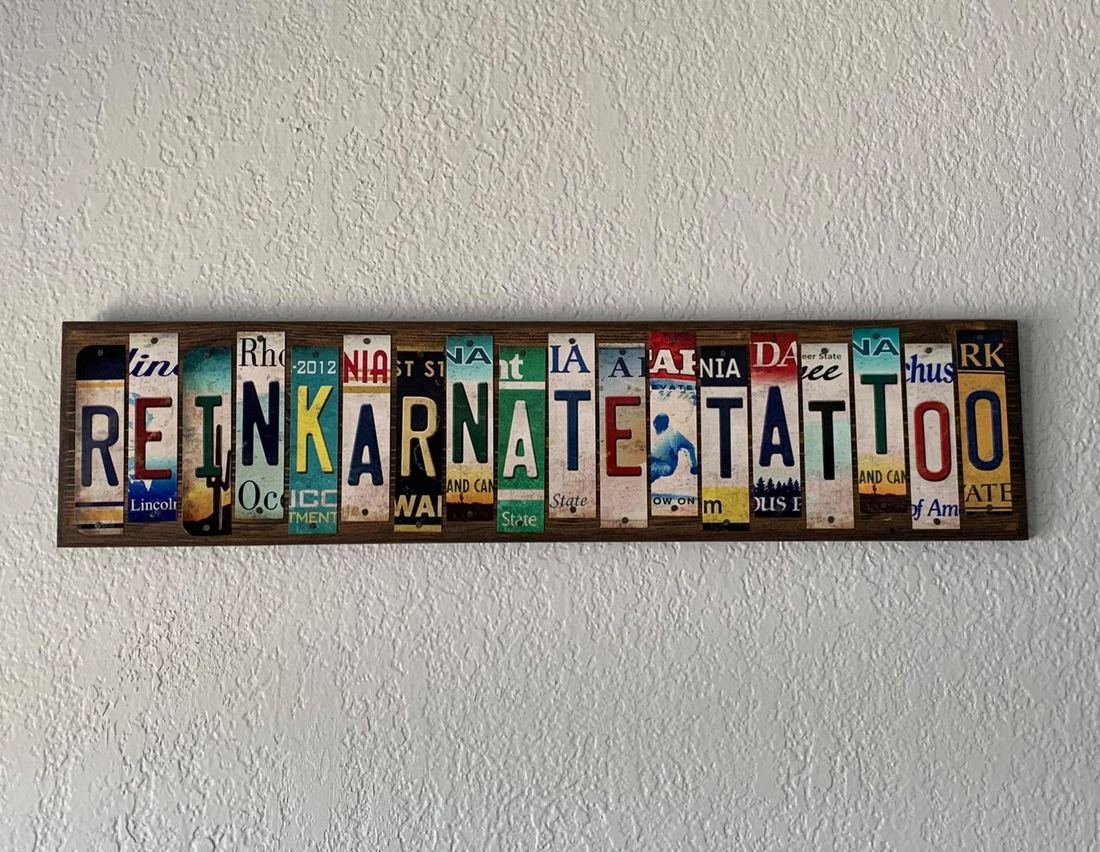 The ReINKarnate Tattoo name sign, spelled out in cut vintage license plates