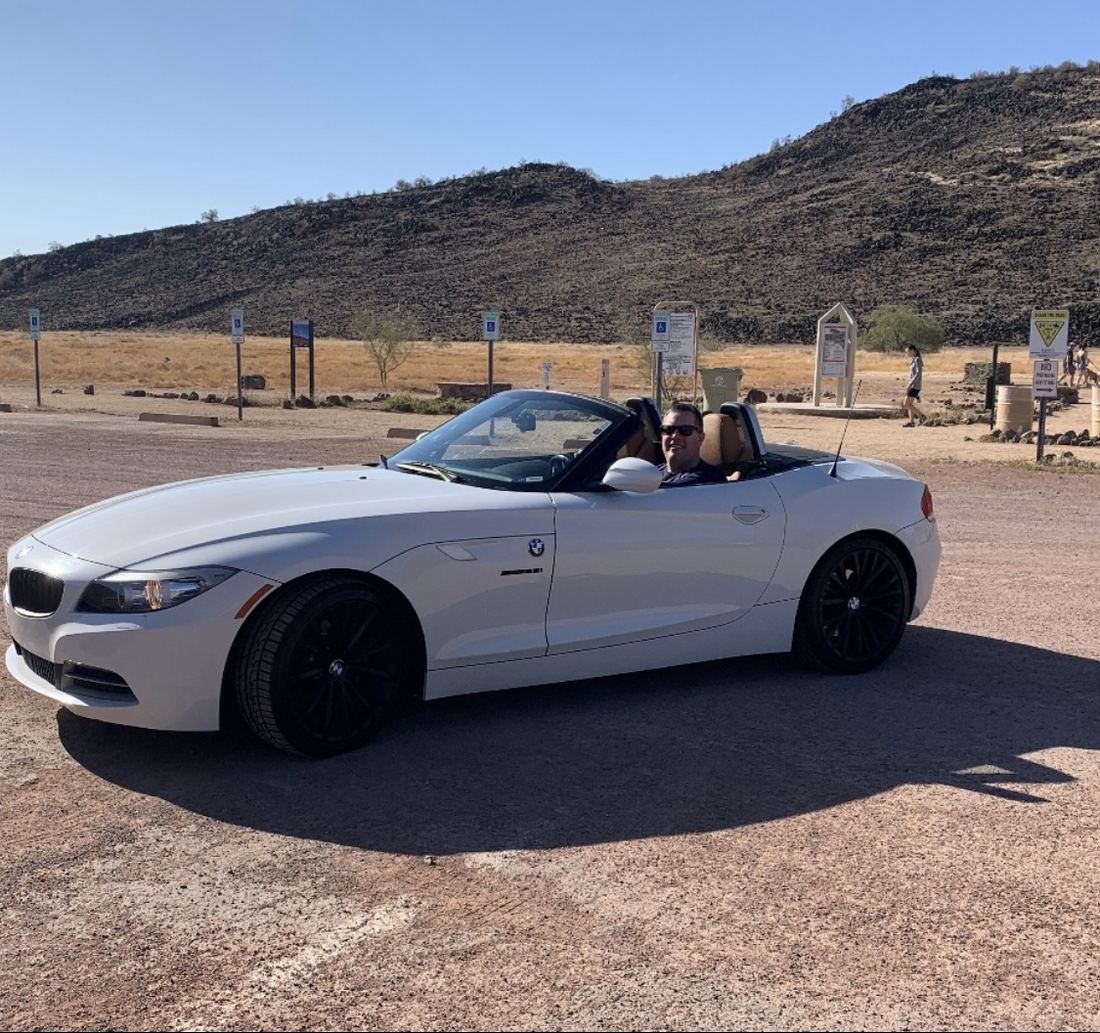 White BMW Z4 roadster with the top down in the desert