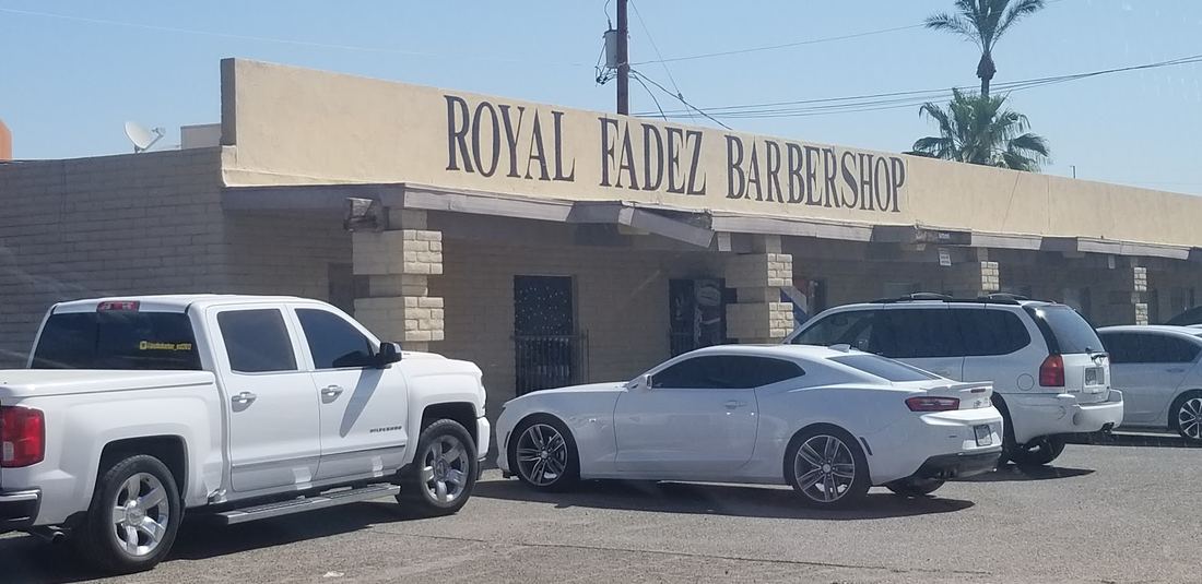 Royal Fadez Barbershop storefront sign on N Arizona Ave with cars parked out front
