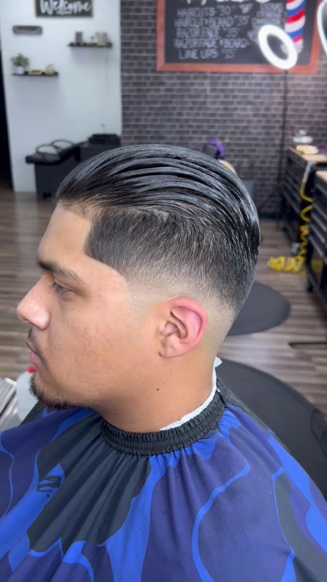 Side profile of a low skin fade with a slicked back top