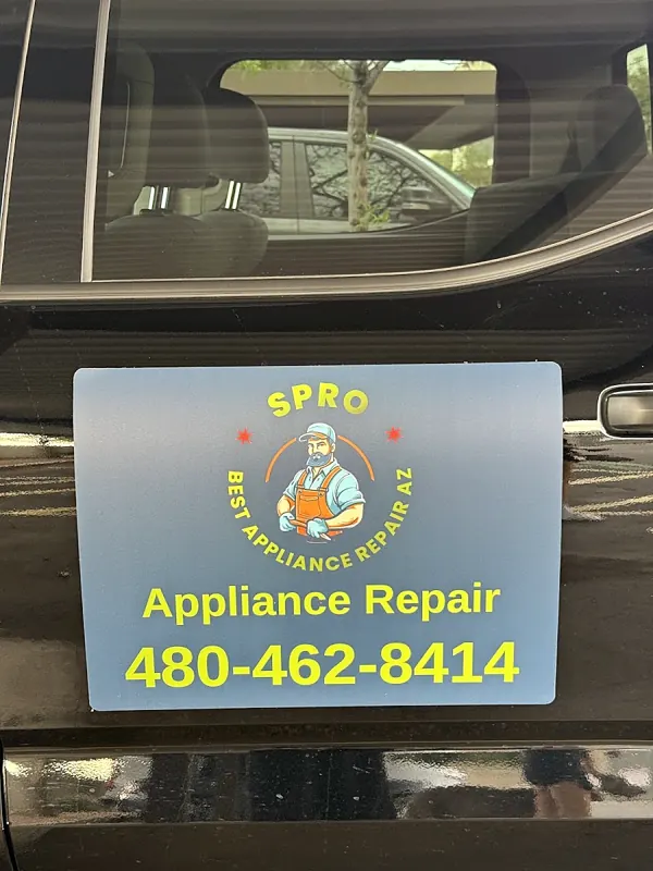 Blue S Pro magnet on a black vehicle door reading Appliance Repair 480-462-8414 with the repairman badge