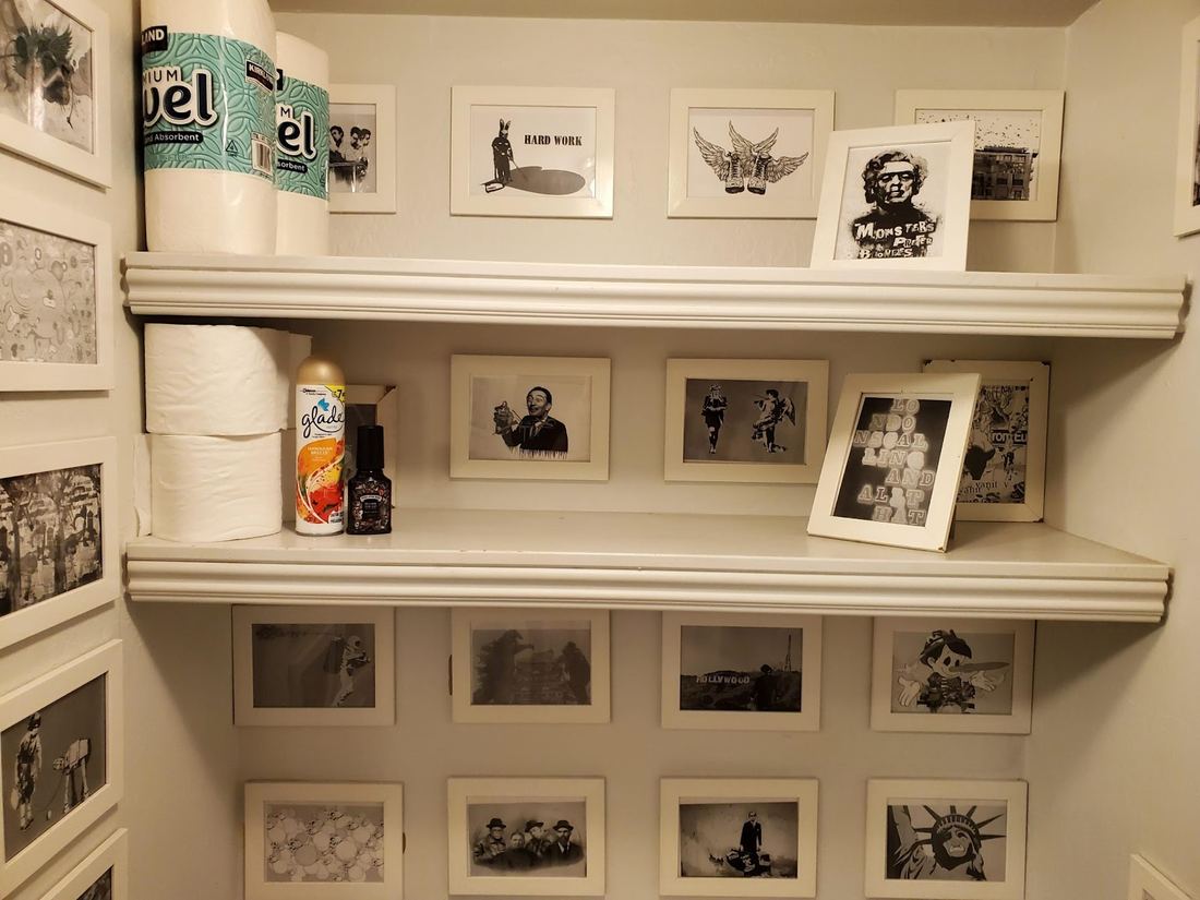 Shelves of framed black and white art prints