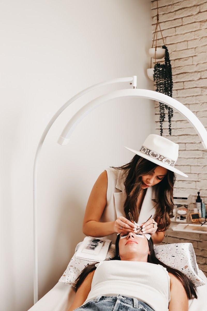 Cassey applying lash extensions to a client in the studio