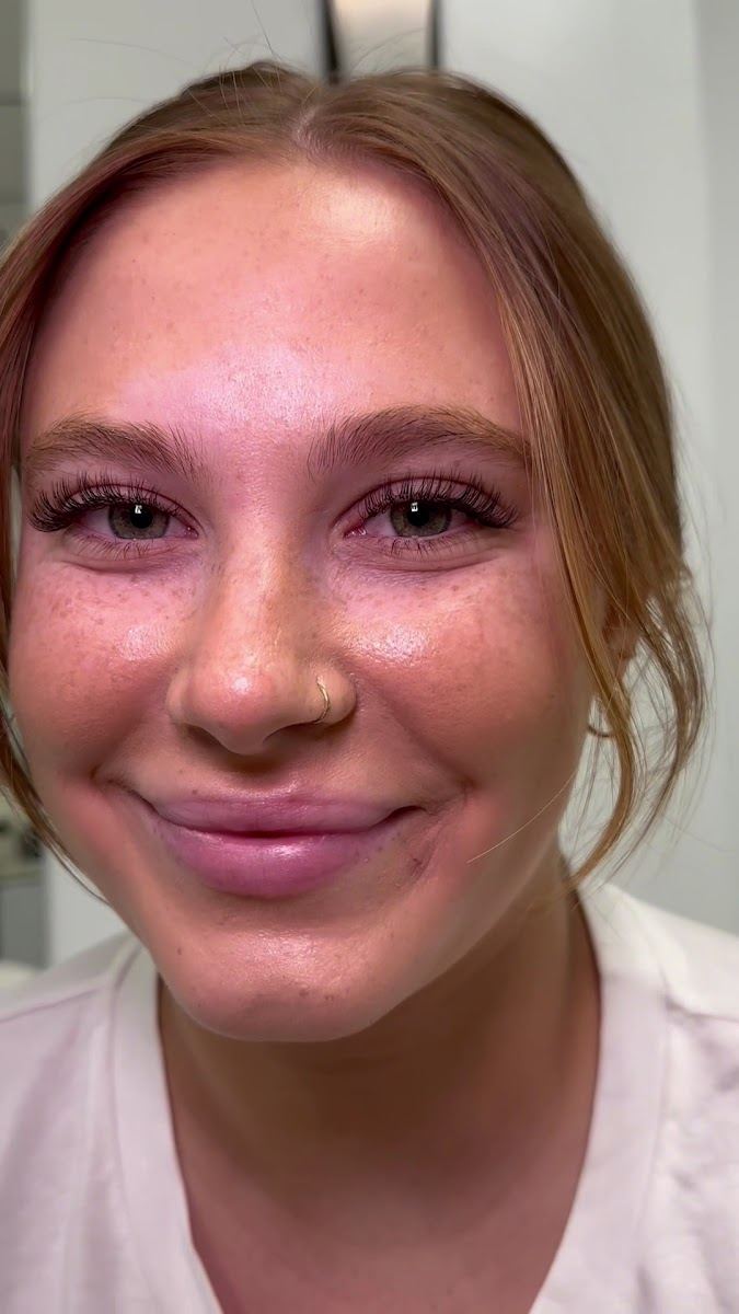 Smiling client showing her new lash extensions
