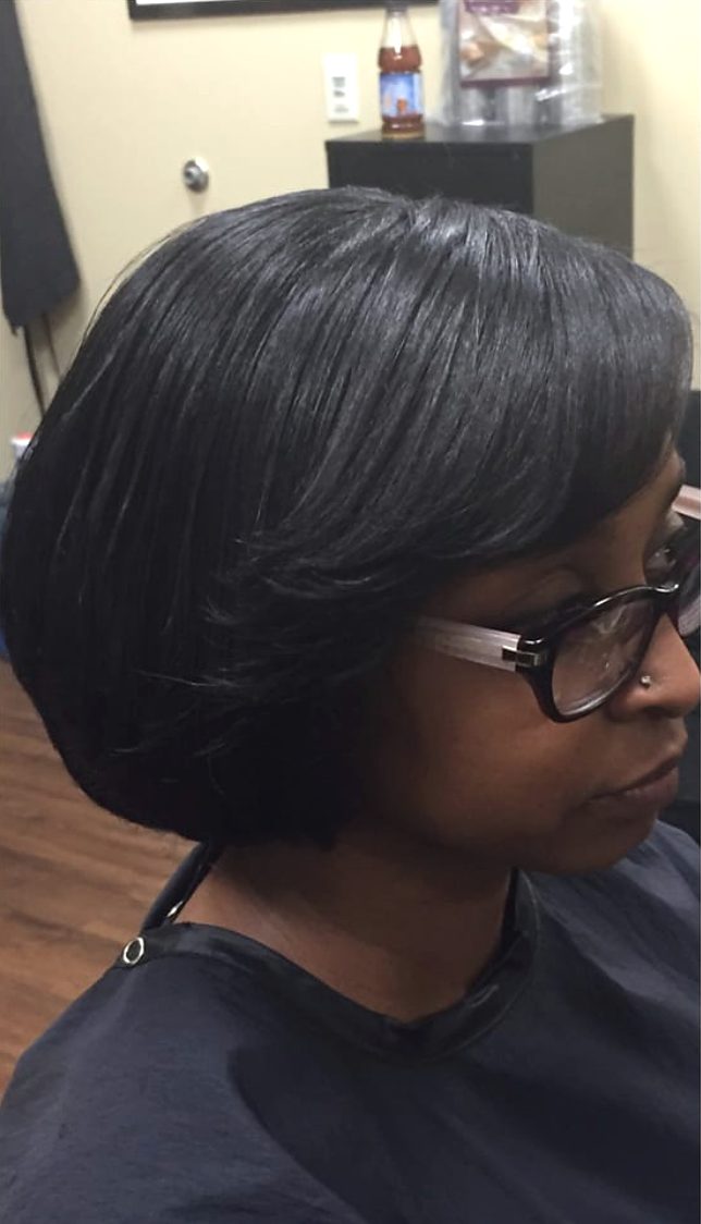 After: the same client with a sleek, glossy pressed bob, side part and swoop