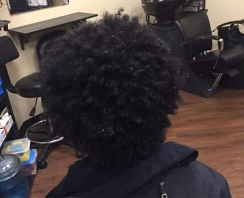 Before: a client's natural, tightly coiled hair from behind