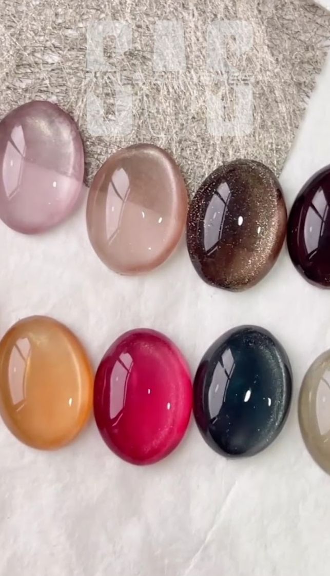 Gel polish color swatches in mauve, nude, brown cat-eye, burgundy, amber, red and navy