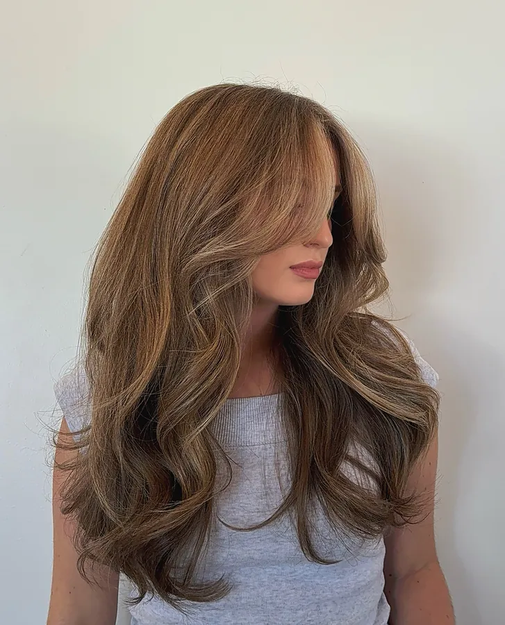 Brunette hair with soft caramel highlights and long layers