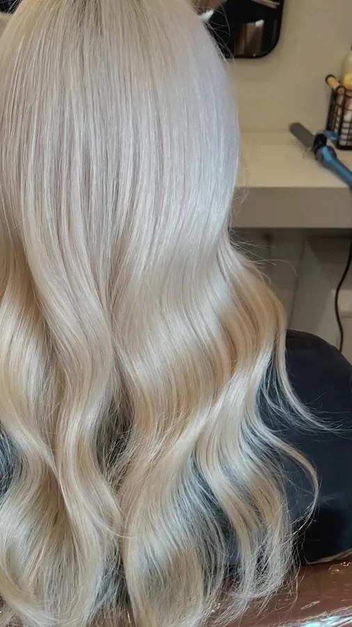 Close view of smooth platinum blonde ends with a soft curl
