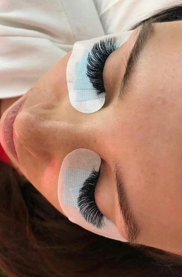 Fresh lash extensions with under eye pads still on