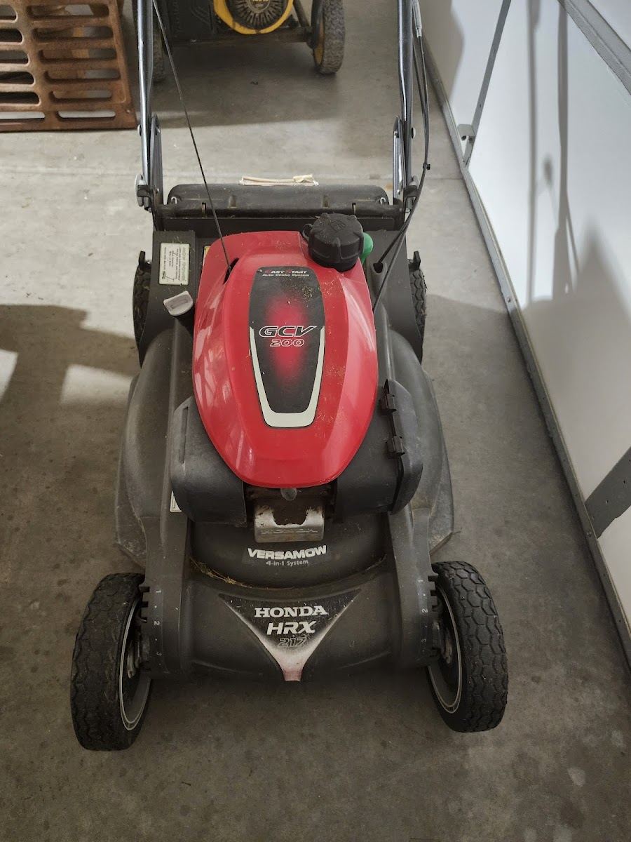 Honda self-propelled push mower in a garage