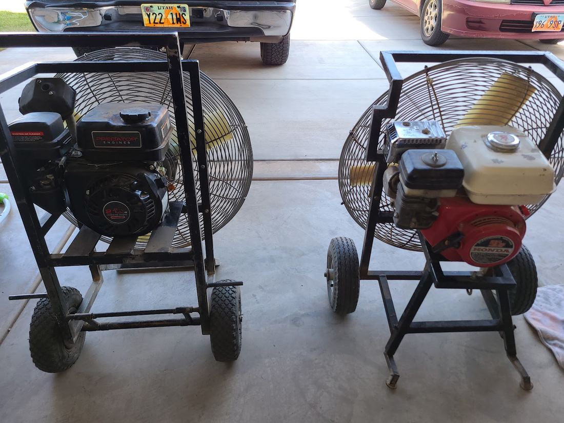Two gas engine driven fans on wheeled stands