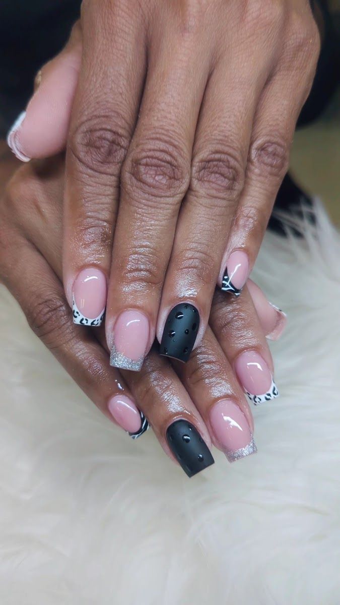 Pink square nails with one matte black accent and black and white tips