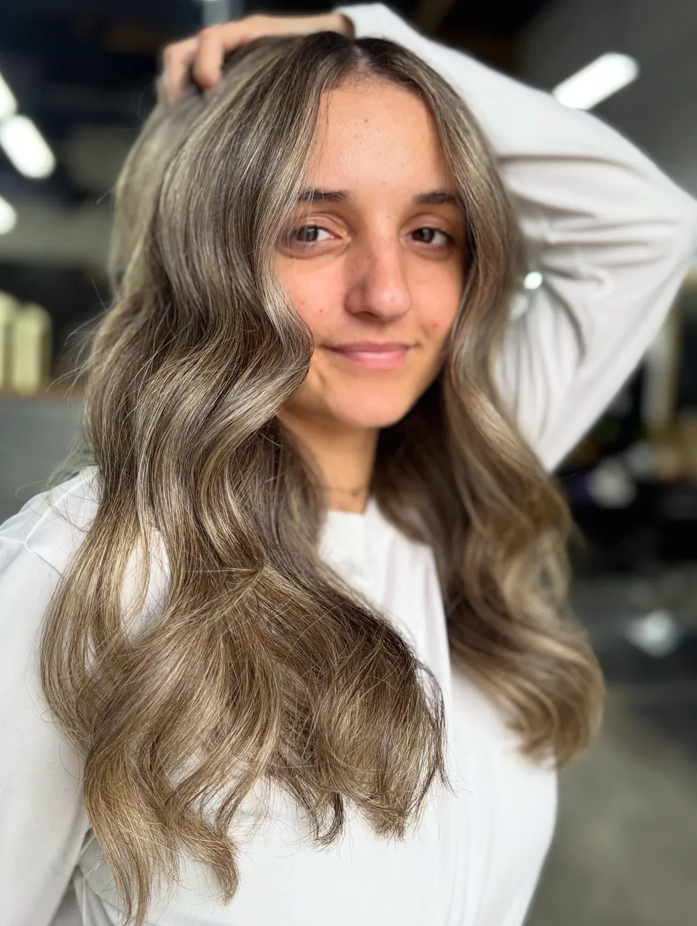Soft bronde waves, darker at the root and lighter toward the ends