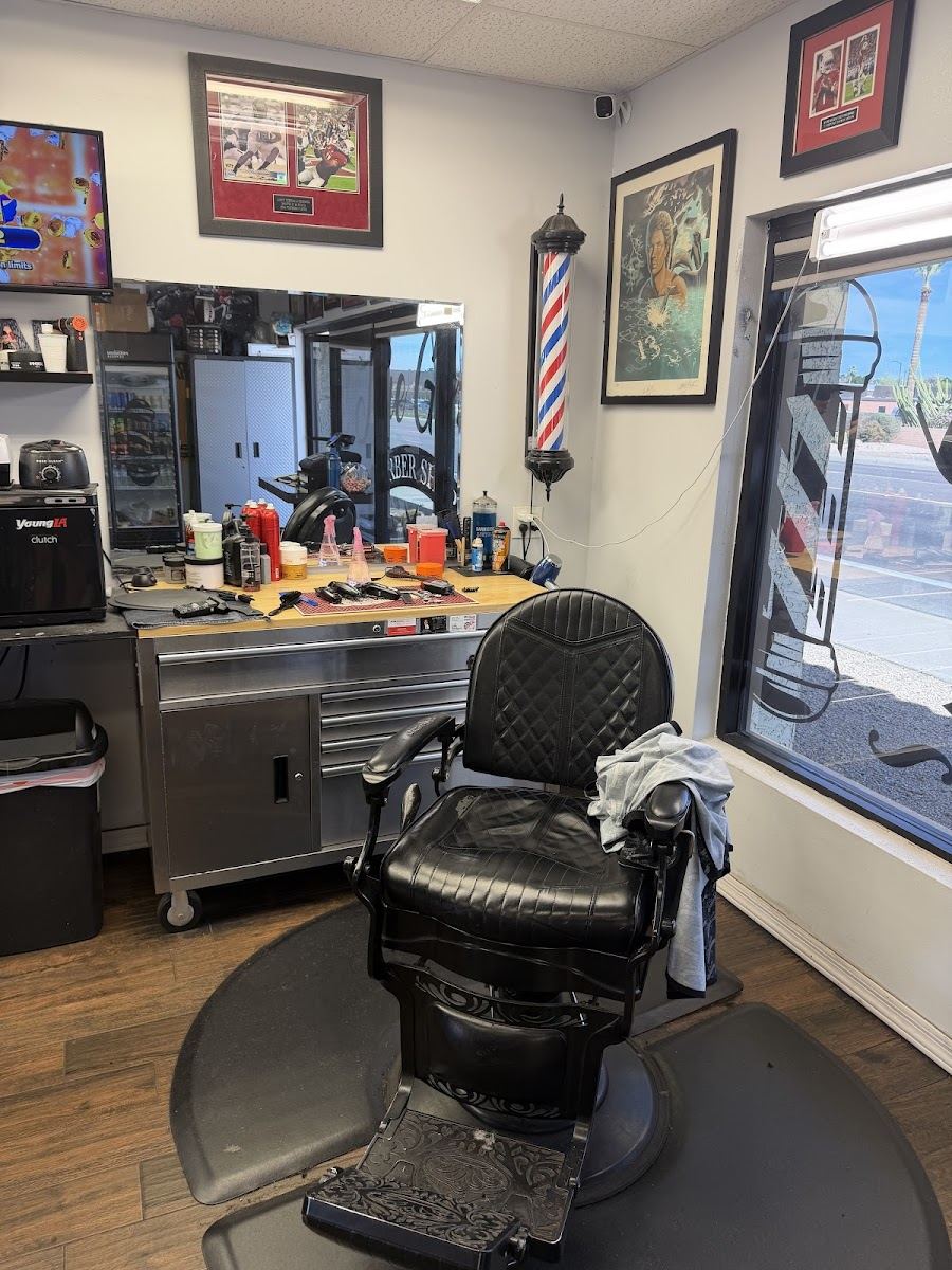Black leather barber chair at a station by the window