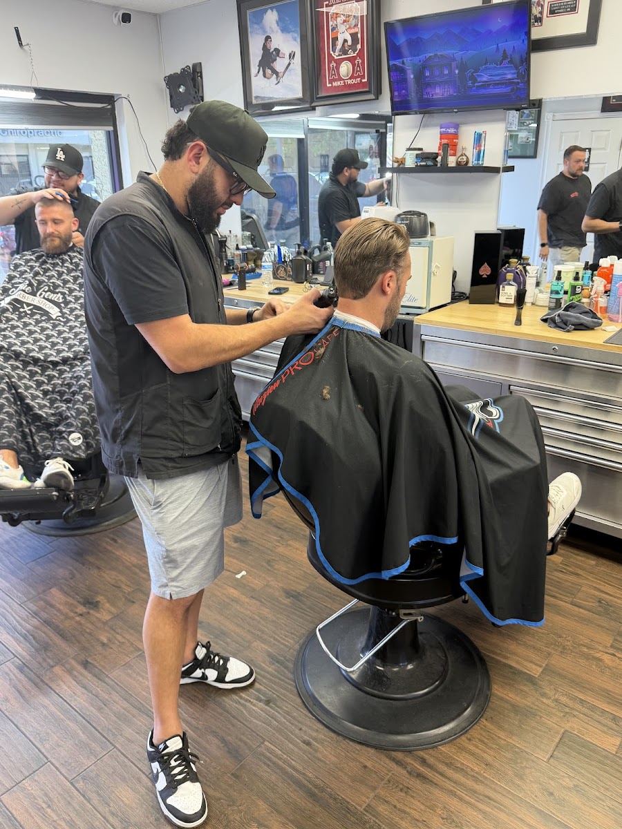 A True Gents barber giving a client a clipper cut