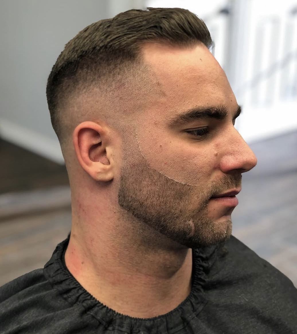 Side profile of a fresh skin fade with a lined beard