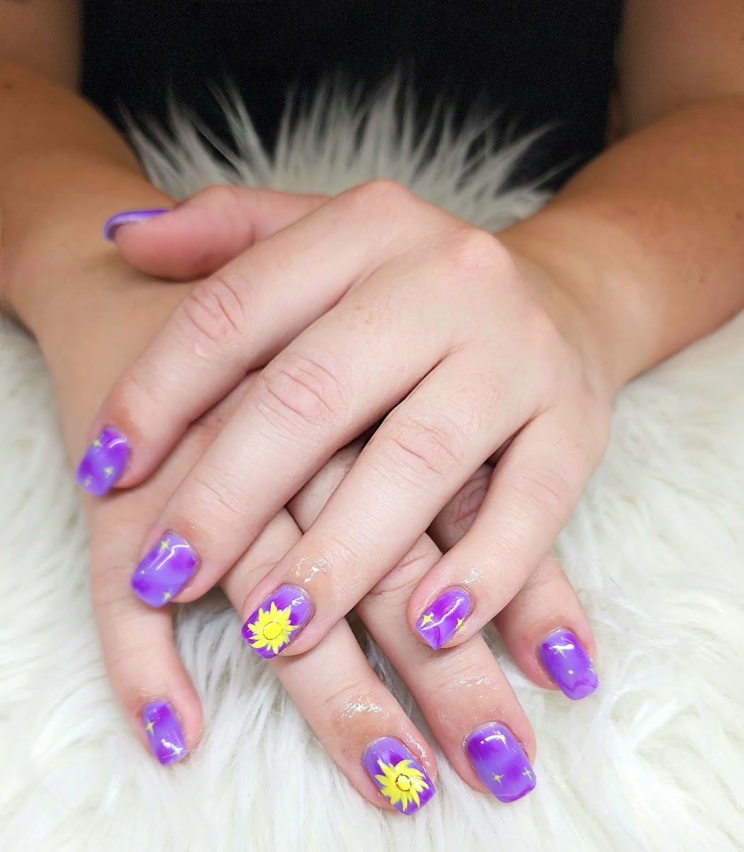 Purple marble nails with yellow flower accents