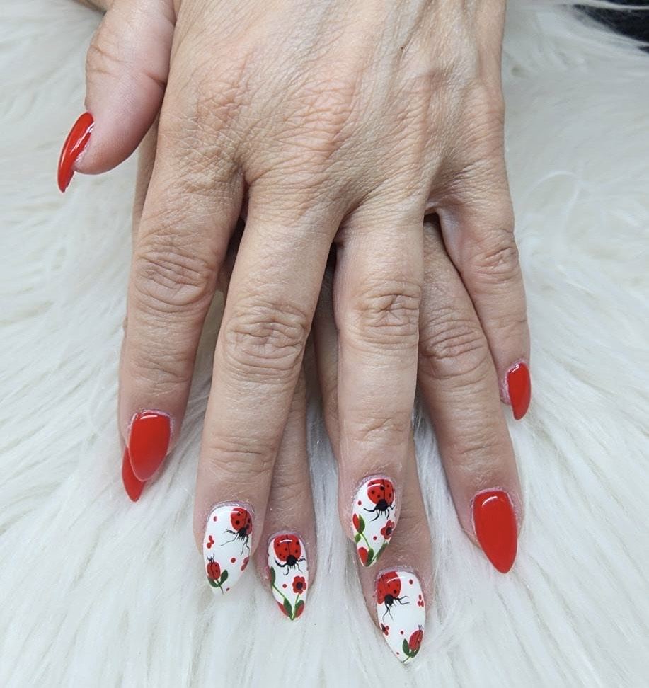 Red nails with white rose accent nails