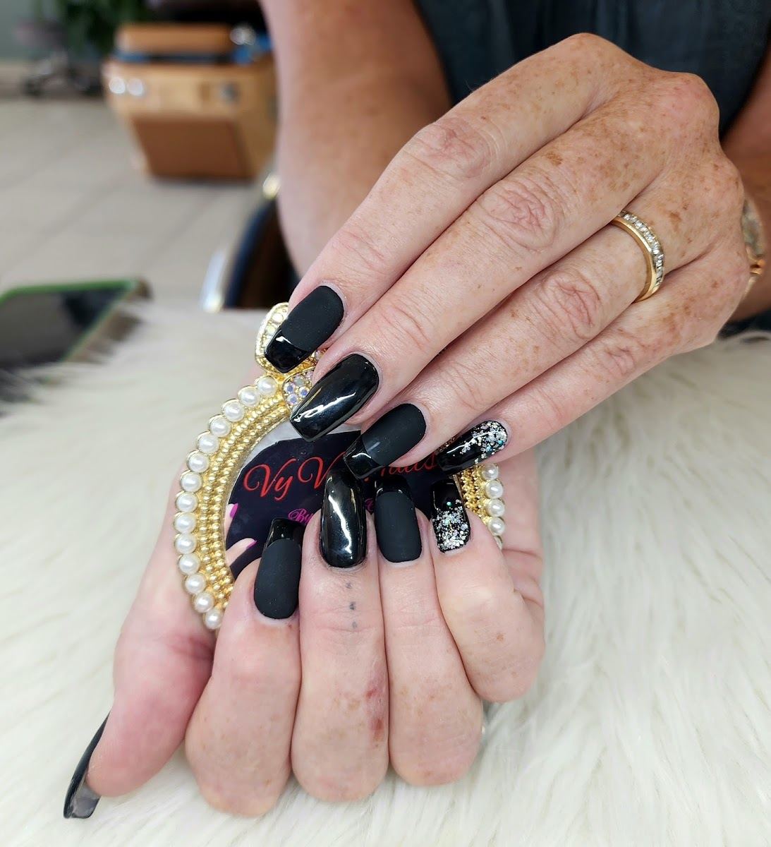 Matte black nails with crystal accents