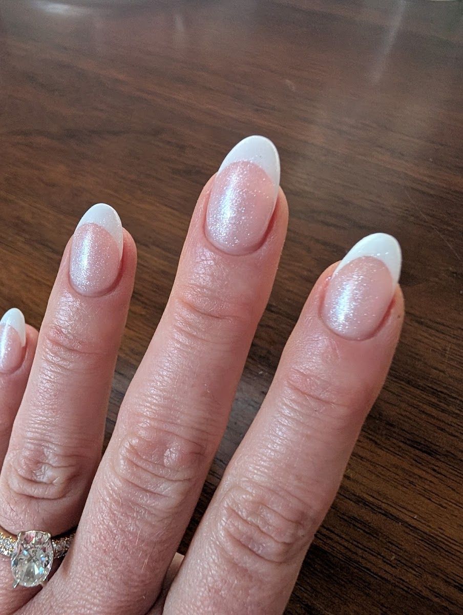 Soft shimmer nails with crisp white French tips