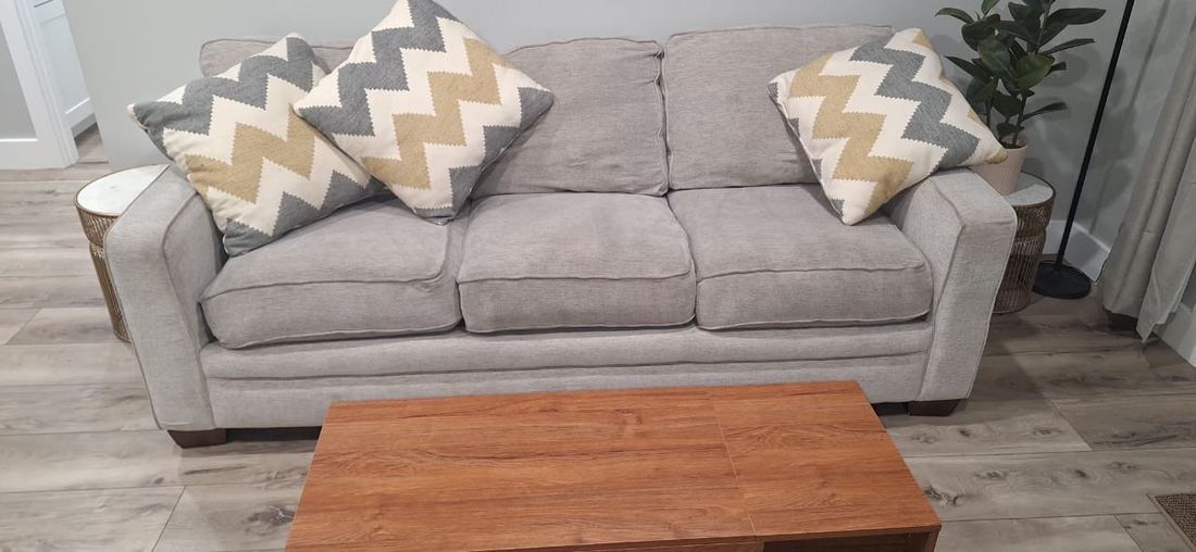 Light gray sofa with chevron pillows