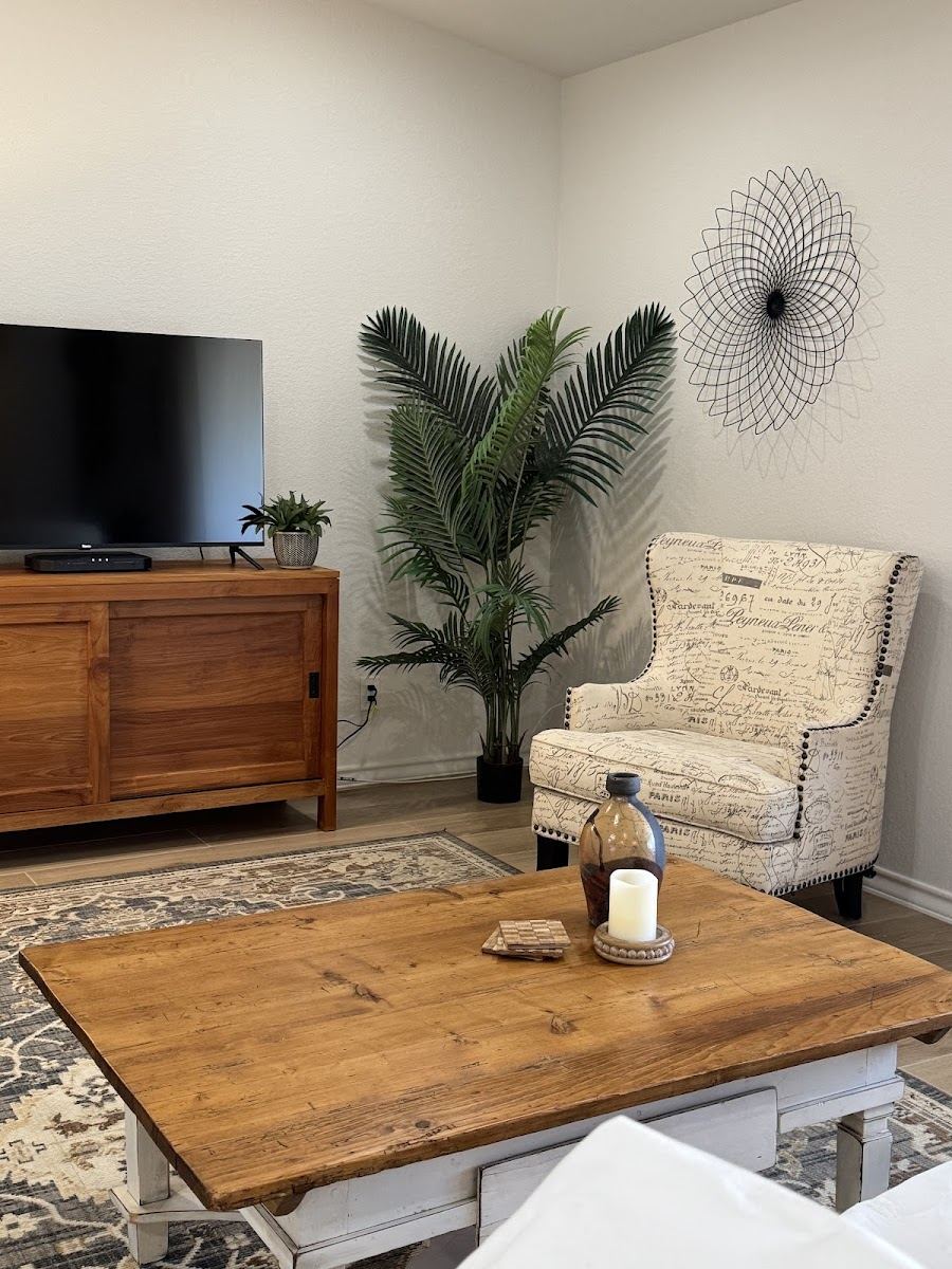 Living room with accent chair, wood coffee table and area rug