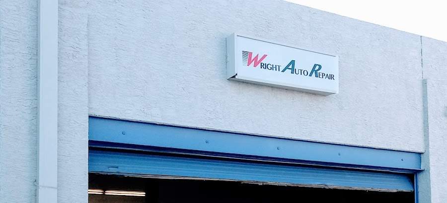 The Wright Auto Repair sign above an open blue bay door