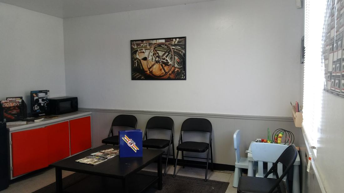 Waiting room with chairs, a table and framed art