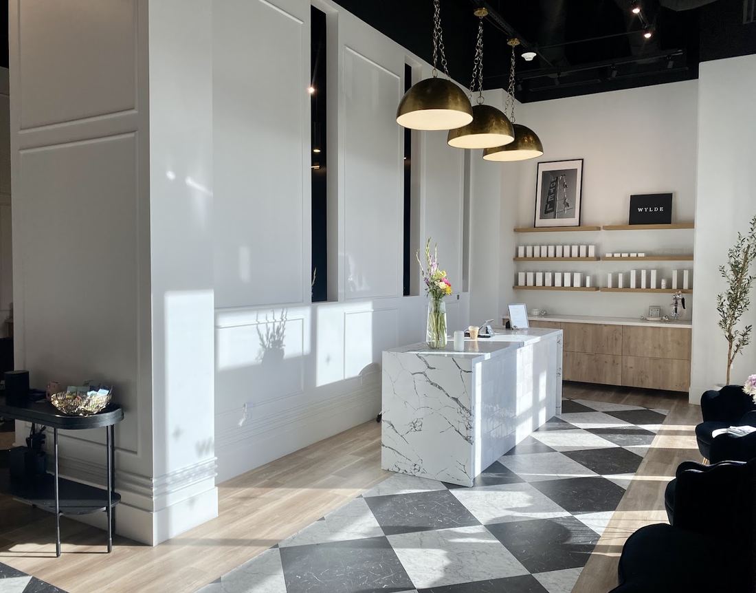Wylde Salon front desk with pendant lights and product shelves