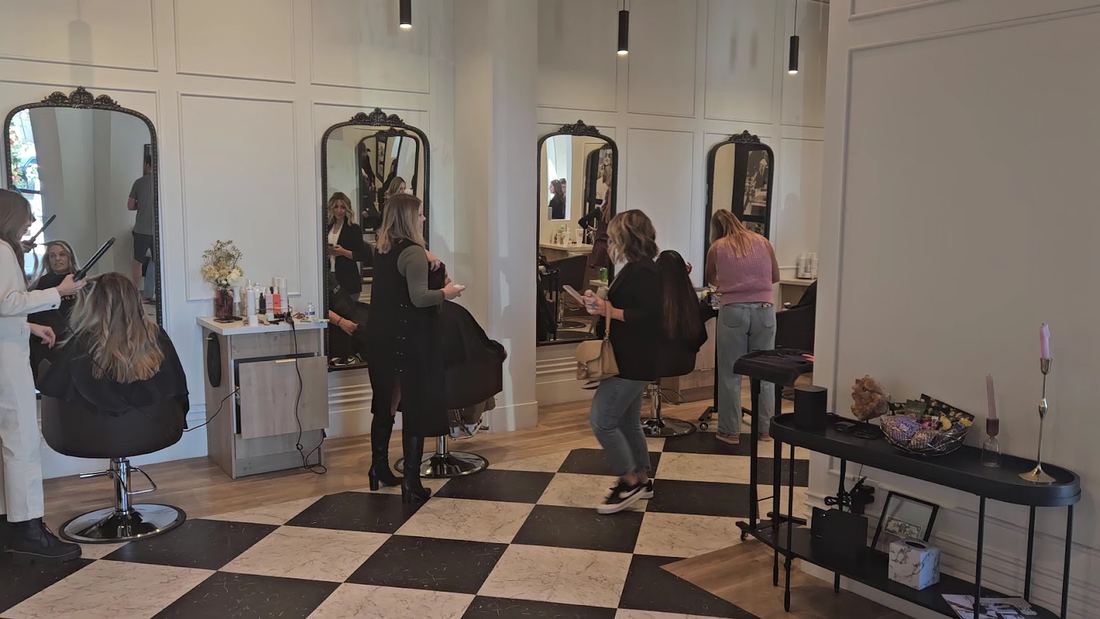 Stylists working at the arched mirror stations