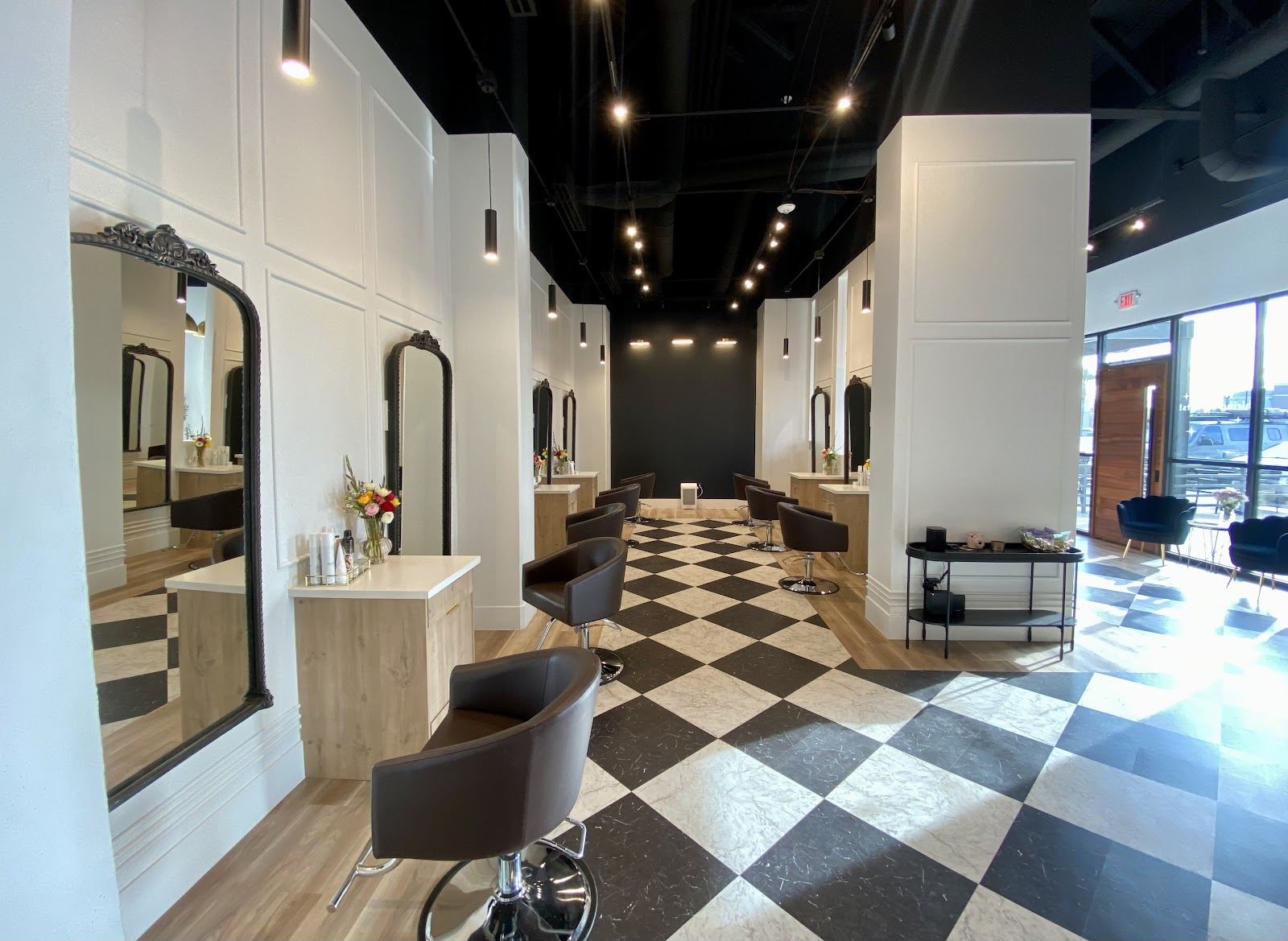Inside Wylde Salon: arched mirrors, styling chairs and black and white checkered floor