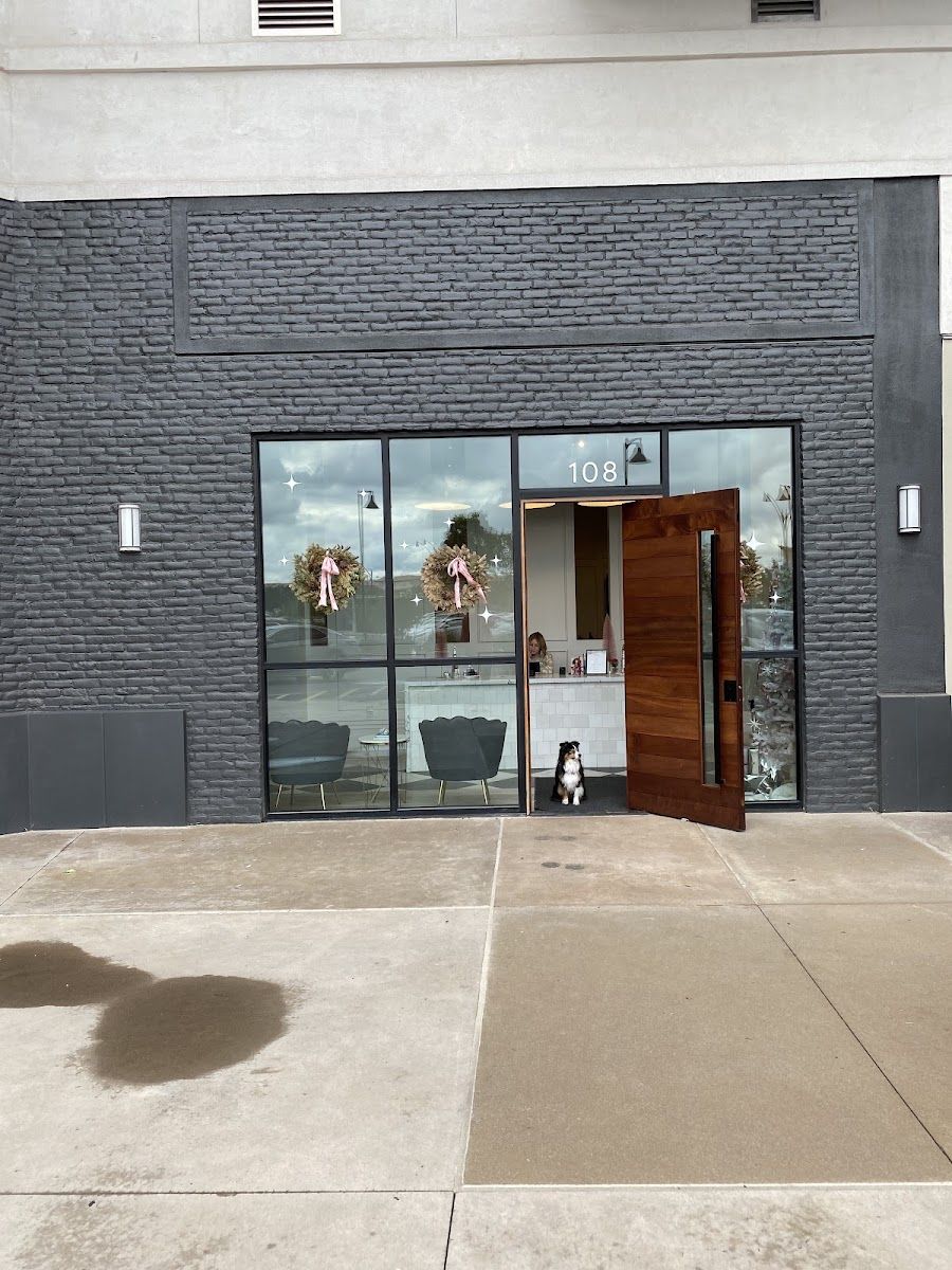 Wylde Salon storefront on the dark brick building with glass doors